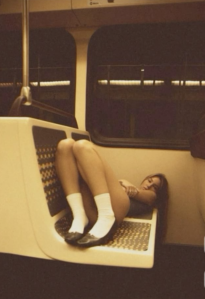 A girl asleep on a night metro seat